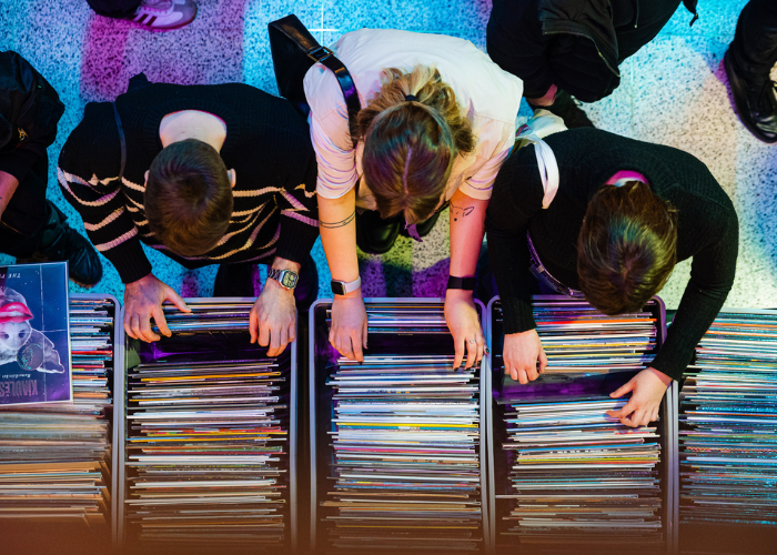 People picking out vinyl records during music fair organized by AGATA